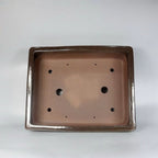 Interior of the ivory rectangular pot showing multiple drainage openings
