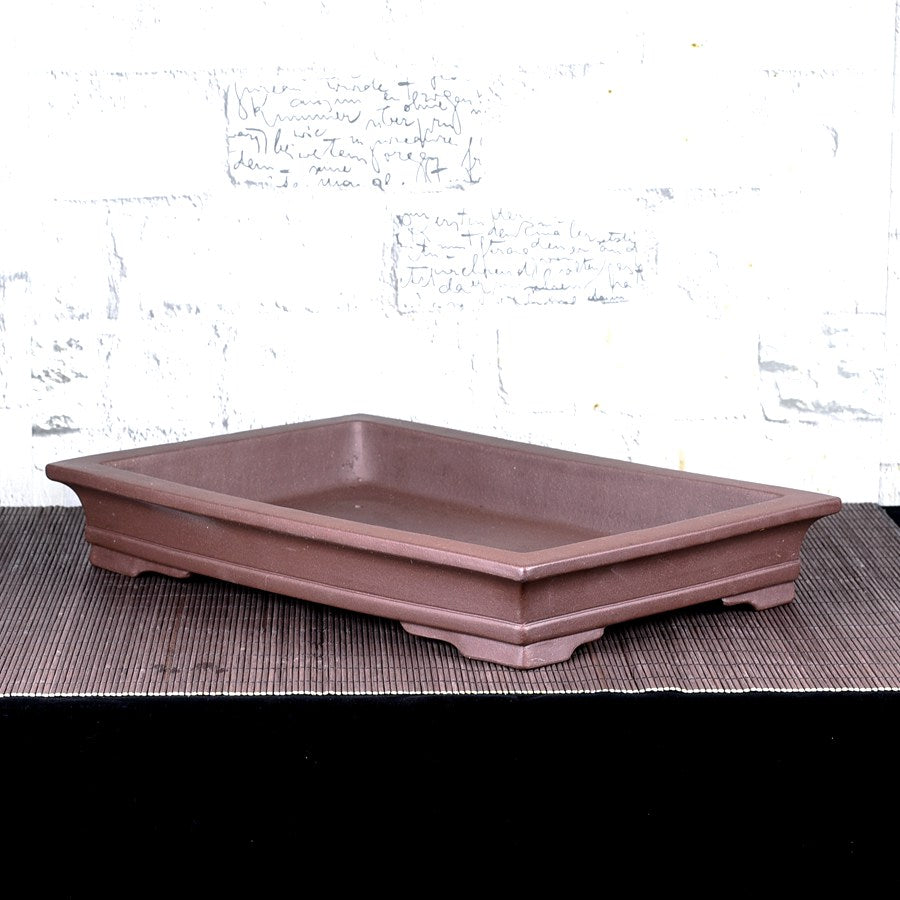 Brown rectangular bonsai pot with flared rim and low feet, angled view