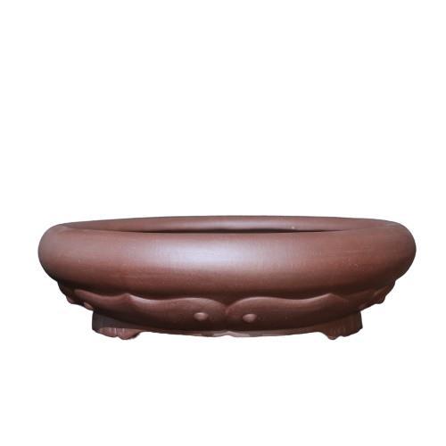 Isolated side view of brown round pot with petal decoration