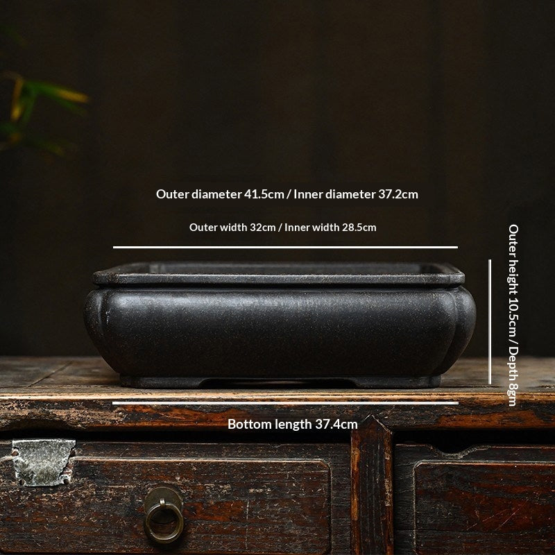 Measurement photograph of the dark rectangular pot showing exterior and interior dimensions
