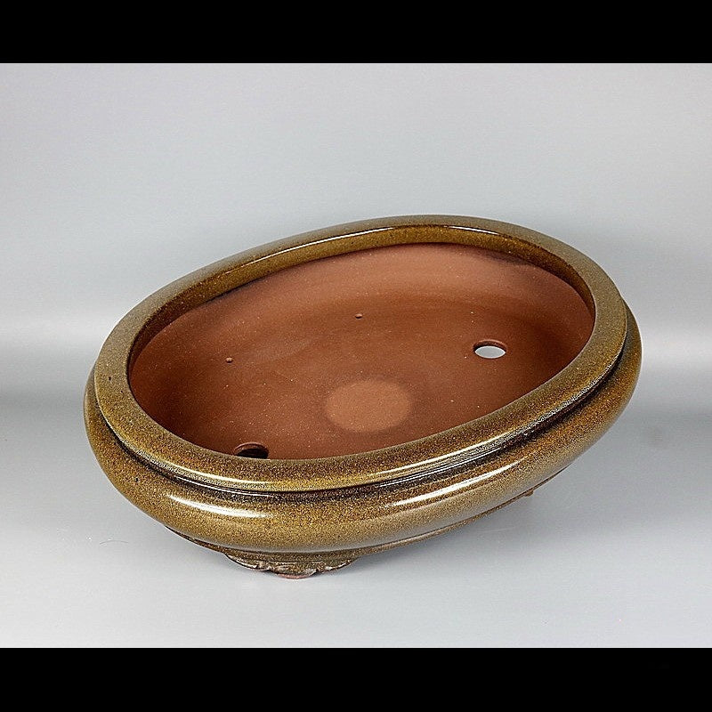 Top view of brown-gold glazed oval pot showing reddish interior and openings