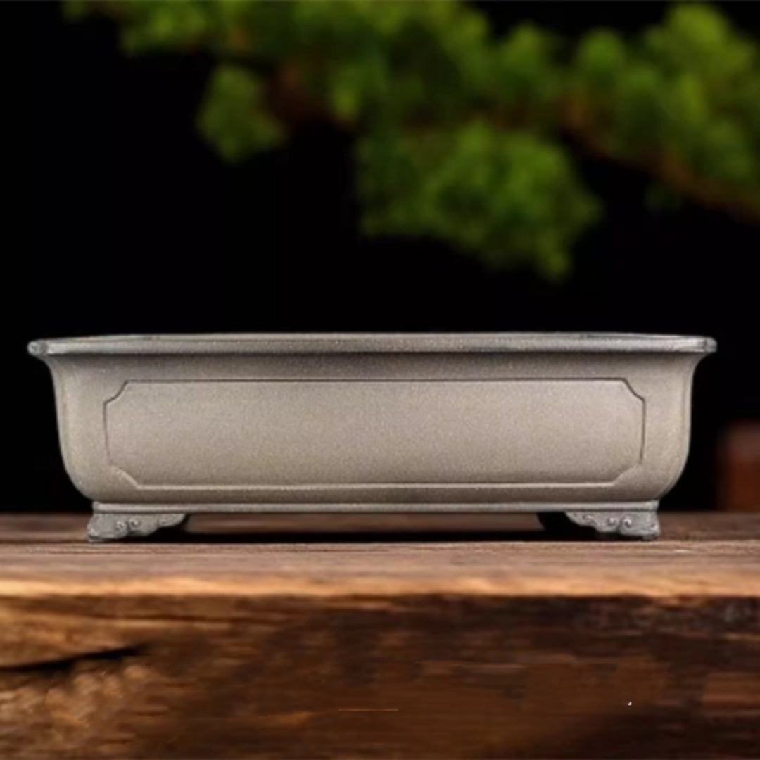 Taupe rectangular bonsai pot with framed side panel and decorative feet