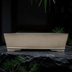 Taupe rectangular pot with straight flaring walls and low feet
