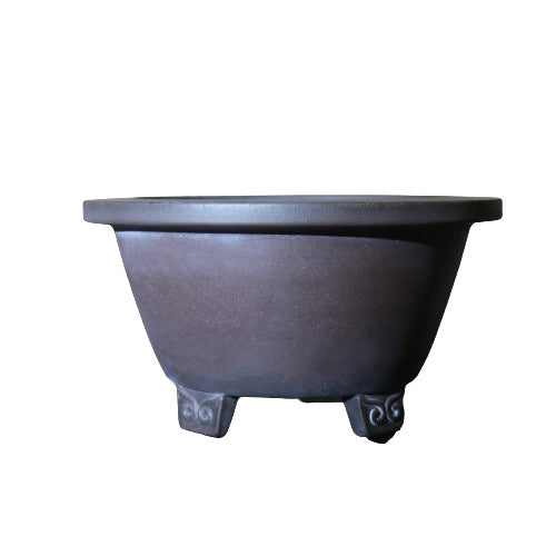 Isolated dark brown round pot with flared rim and decorative feet