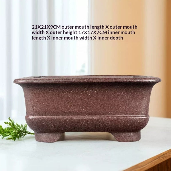 Brown square pot on a windowsill with measurement labels