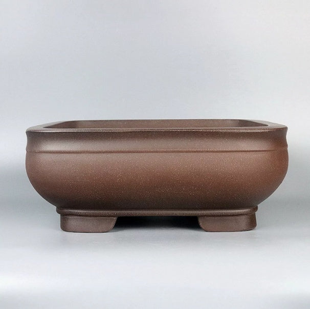Front view of the rounded square brown pot
