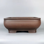 Front view of the rounded square brown pot