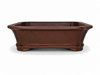 Brown rectangular bonsai pot with flared rim, tapered walls and shaped feet