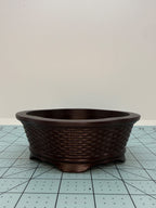 Opposite side of the brown oval pot with basket-weave relief