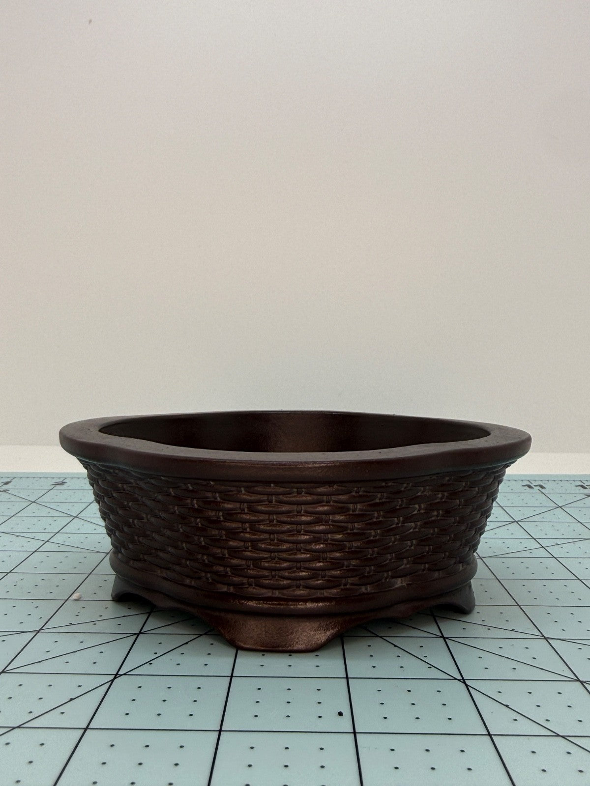 Opposite side of the brown oval pot with basket-weave relief