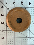Underside of the ochre oval pot showing a central drainage hole and short feet