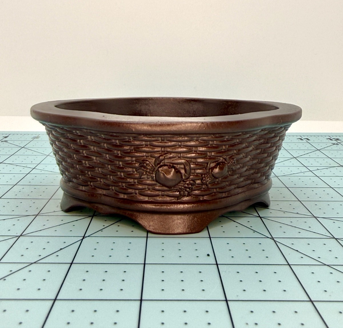 Front view of the brown basket-weave pot showing a raised ring ornament