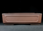 Front view of the plain brown paneled rectangular pot