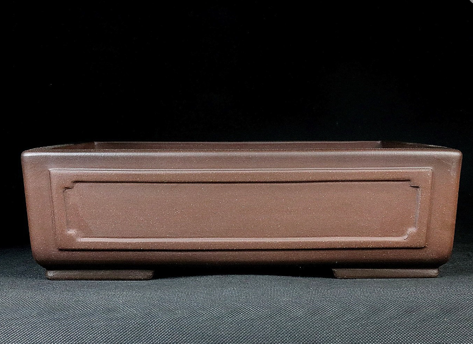 Front view of the plain brown paneled rectangular pot
