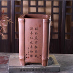 Tall reddish-brown square pot with bamboo-joint corners and calligraphy panel