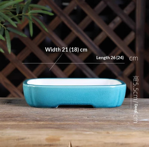 Turquoise oval bonsai pot with a pale interior, low feet and measurement labels