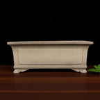 Taupe rectangular pot with recessed panels and curled feet