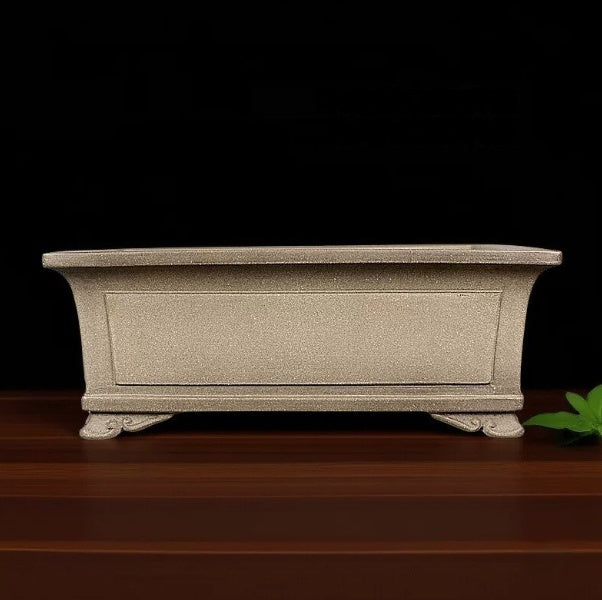 Taupe rectangular pot with recessed panels and curled feet