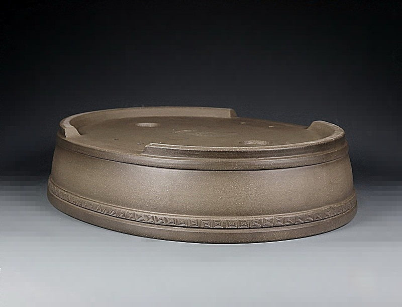 Taupe oval pot upside down showing its raised foot ring