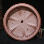 Top view of round pot showing lobed interior and central opening