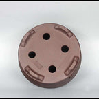 Round clay pot underside with four drainage openings