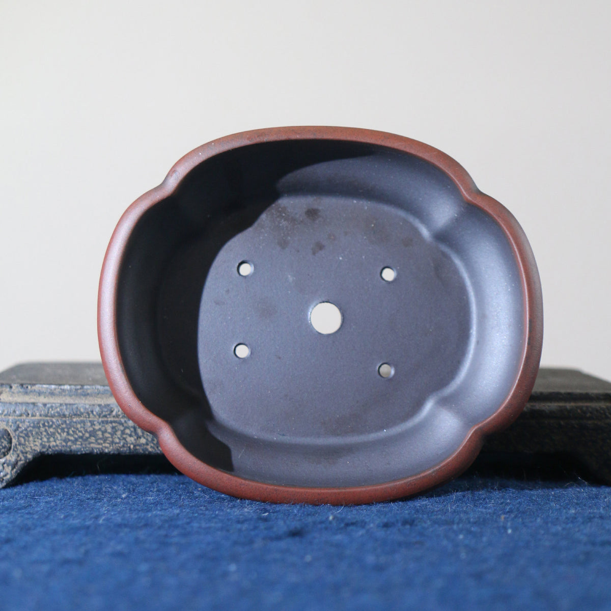 Top view of lobed bonsai pot showing a large central opening and four small holes