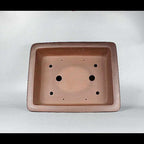 Top view of brown rectangular pot showing two large openings and additional smaller holes
