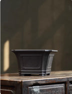 Alternate front view of dark square bonsai pot with banded base