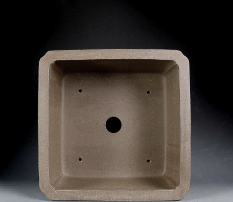 Top view of taupe square pot showing central opening and four small holes