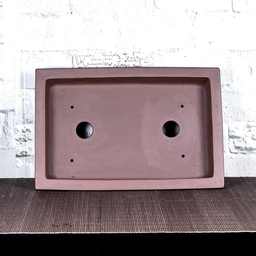 Top view of brown rectangular bonsai pot showing two large and four small holes