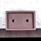 Top view of brown rectangular bonsai pot showing two large and four small holes