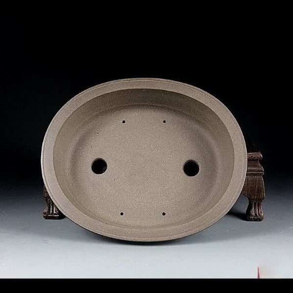 Top view of taupe oval pot showing two large openings and four small holes