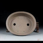 Top view of taupe oval pot showing two large openings and four small holes