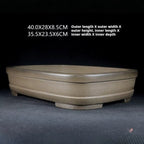 Angled rounded rectangular pot with dimension annotations