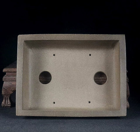Interior of the taupe rectangular pot with two drainage holes and smaller openings