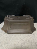 Upside-down dark brown clipped-corner pot showing base and feet