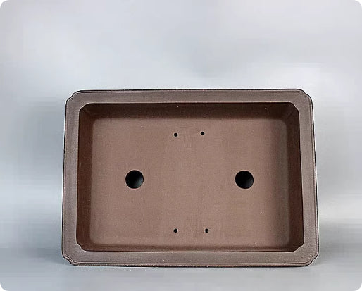 Top view of brown rectangular pot showing two large openings and four small holes