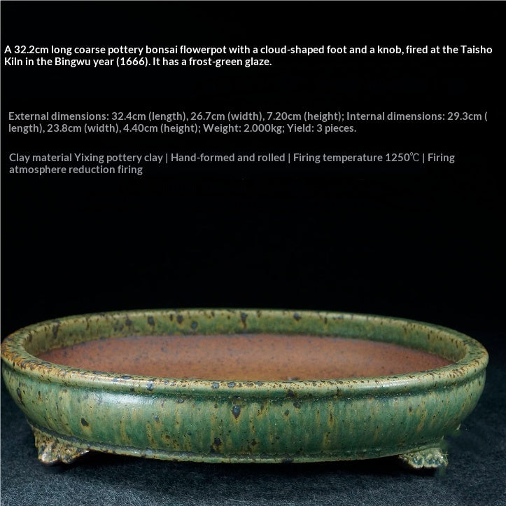 Green drip-glazed oval bonsai pot with a brown interior and short decorative feet, with dimensions above