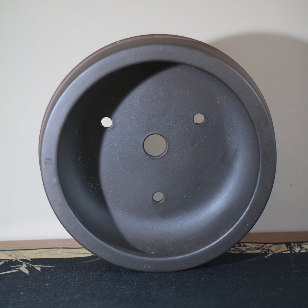 Round clay pot interior with drainage and wiring holes