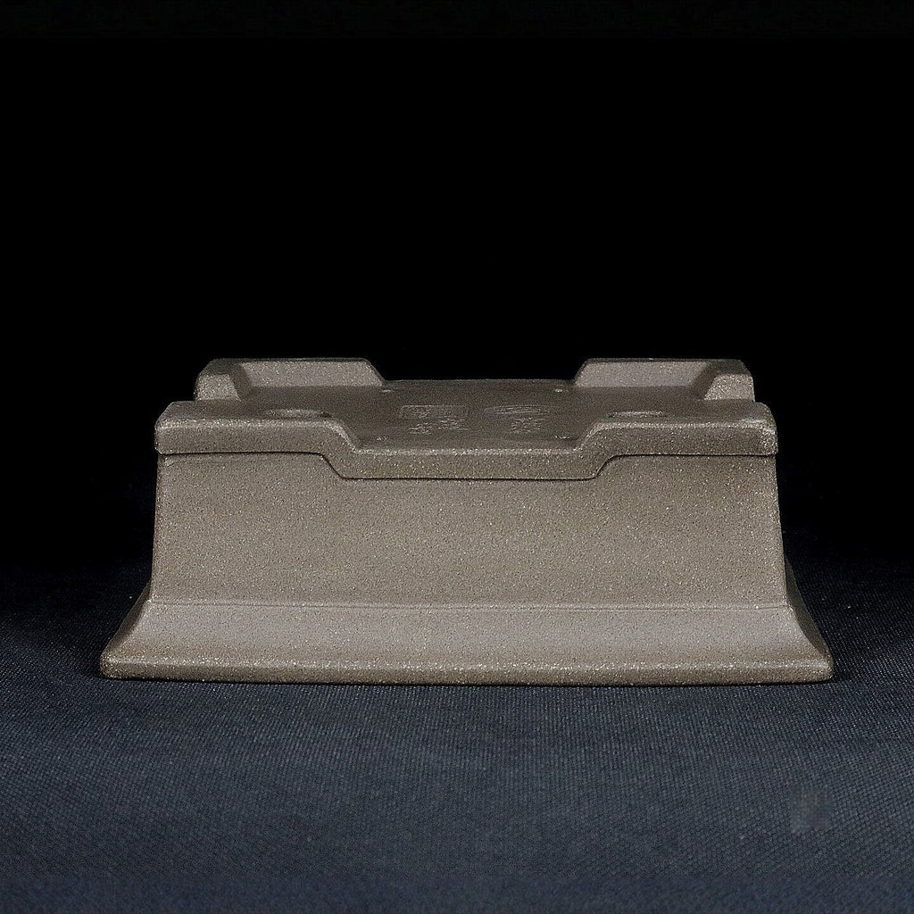 Upside-down gray rectangular pot showing raised feet and base profile