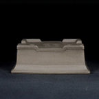 Upside-down gray rectangular pot showing raised feet and base profile