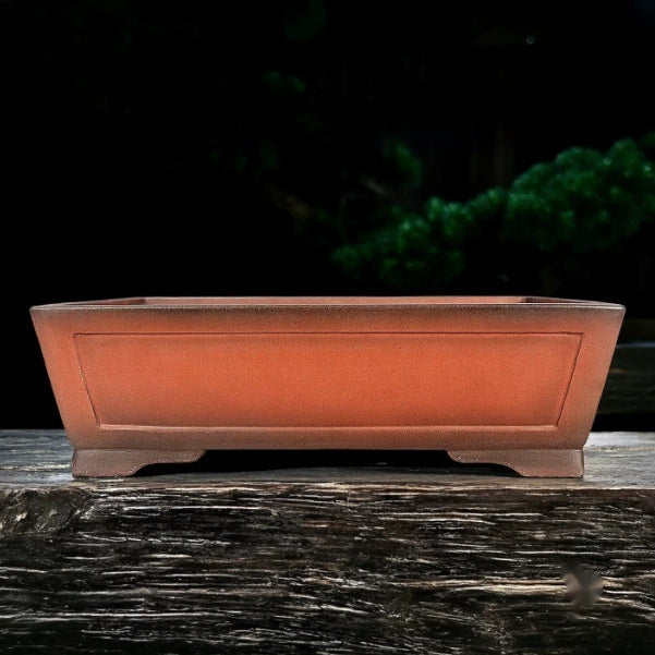 Orange-brown rectangular bonsai pot with recessed side panel and low feet