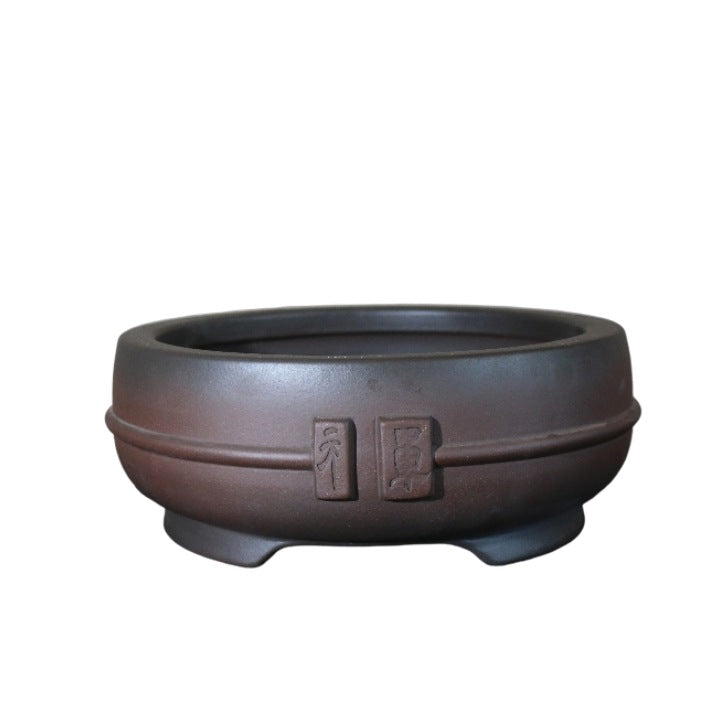 Dark-brown round bonsai pot on white background