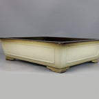 Ivory-glazed rectangular pot with recessed panels and darker edges