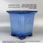 Angled blue square pot with paneled sides, decorative feet and measurement labels