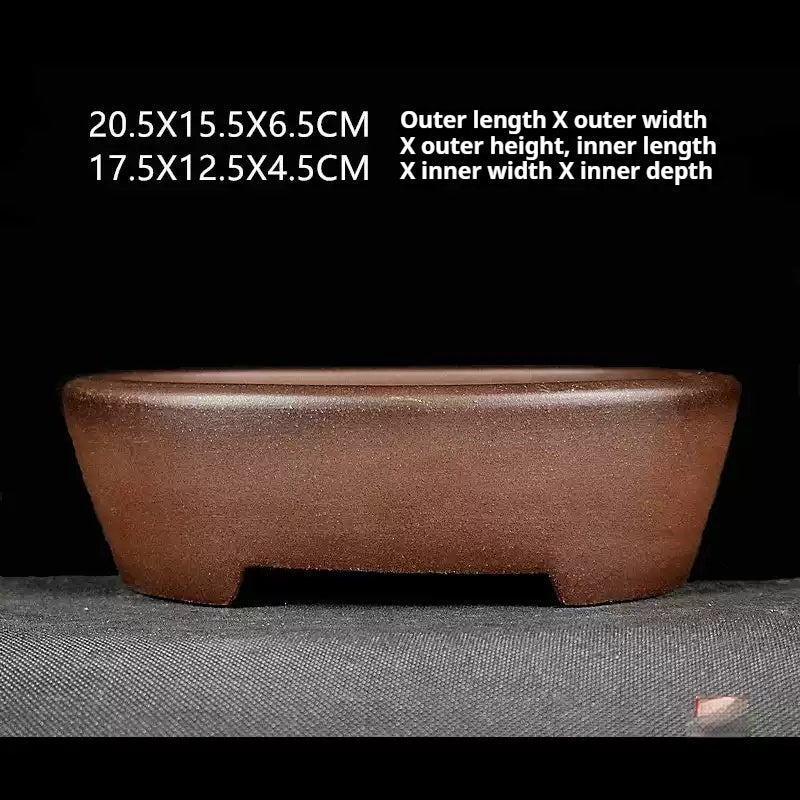 Brown oval pot with low cutout feet and measurement annotations