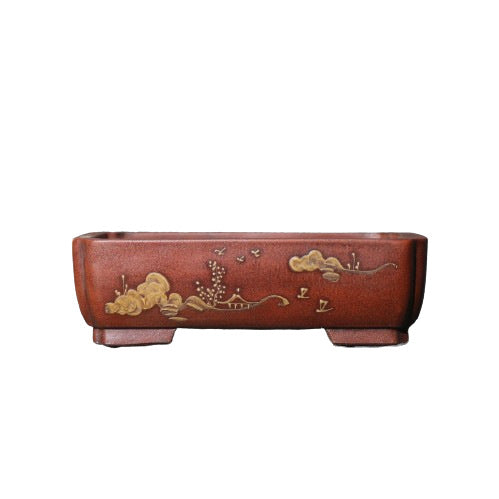 Isolated red-brown pot with gold-colored landscape motif