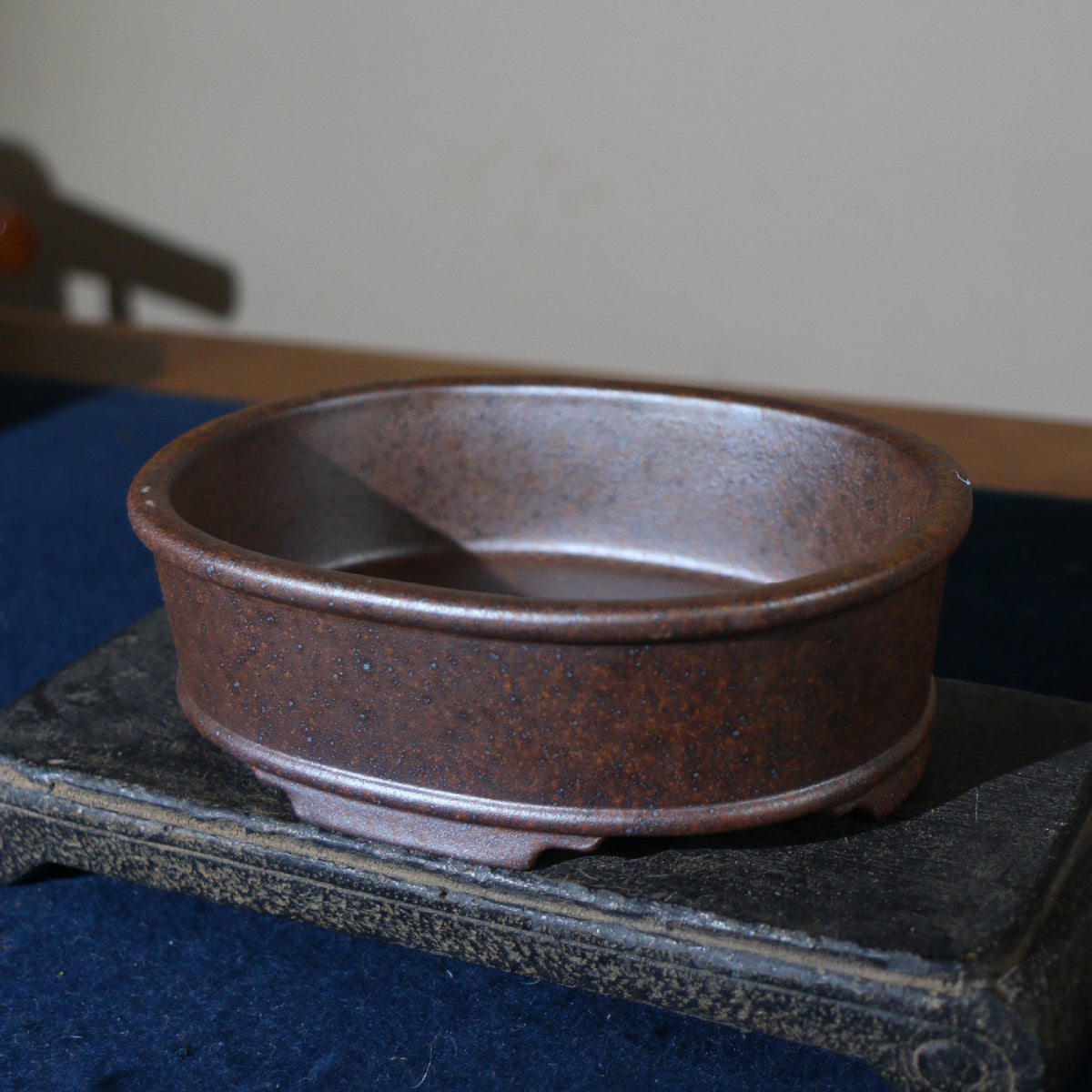 Angled view of mottled brown oval pot showing interior