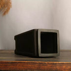 Tall charcoal square pot lying on its side to show deep interior