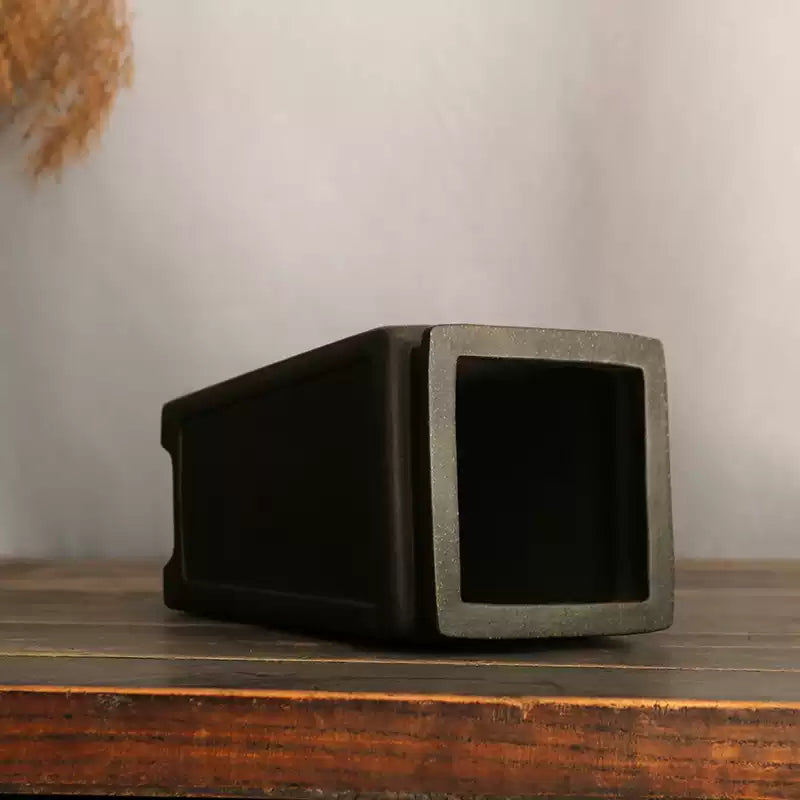 Tall charcoal square pot lying on its side to show deep interior